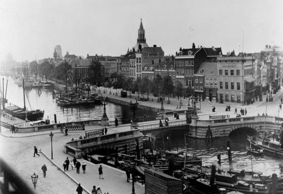 foto van grote hoogte genomen over de Leuvehaven met wandelaars over een brug.