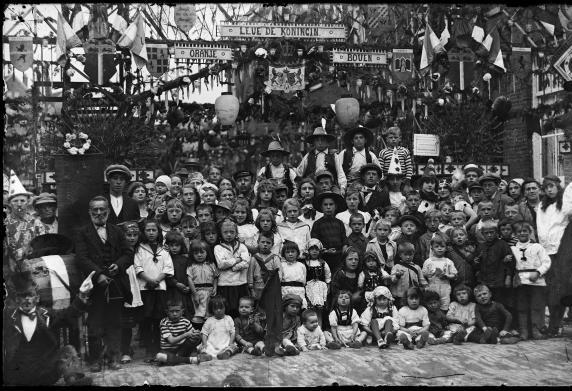 Een grote groep kinderen poseert in de versierde Isac Hubertstraat 1923.